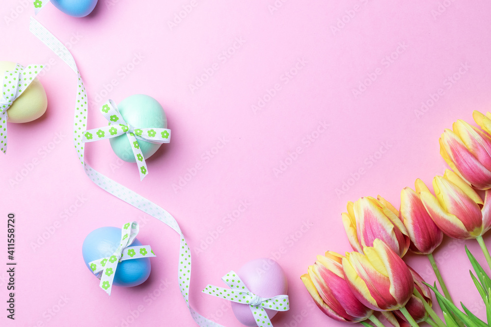 Easter message. Colorful egg with tape ribbon, spring tulips, feathers on pastel pink background in Happy Easter decoration. Foil minimalist egg design, modern top view template. Easter message. Colorful egg with tape ribbon, spring tulips, feathers on pastel pink background in Happy Easter decoration. Foil minimalist egg design, modern top view template.
