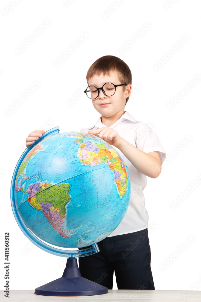 a boy with glasses, an elementary school student, stands next to a globe, an isolate on a white background a boy with glasses, an elementary school student, stands next to a globe, an isolate on a white background