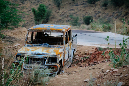 Abandoned and burnt-out car. A burnt-out car left abandoned at the road side of a quiet rural location