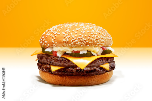 Delicious Double Cheese Beef Burger consists of Bun Bread, Patty, Pickle, Onion, Mayonaisse, Ketchup and Cheddar Cheese in a yellow background, with interactive 3D text for Modern Fast Food Restaurant