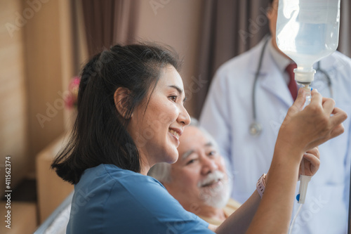 Nurses support the elderly patient man to resting at hospital room, medical health care and old disease insurance concept