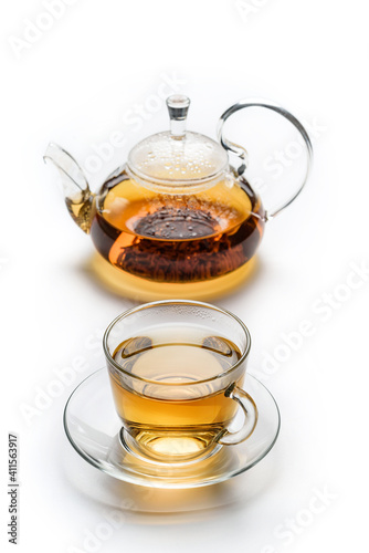 Cup with tea and teapot isolated on white background.