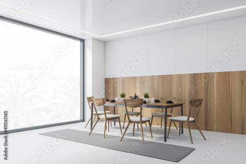 White and wooden dining room with chairs and table near window