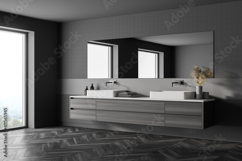 Modern bathroom with grey walls  double sink with big mirror  wooden parquet  window light.