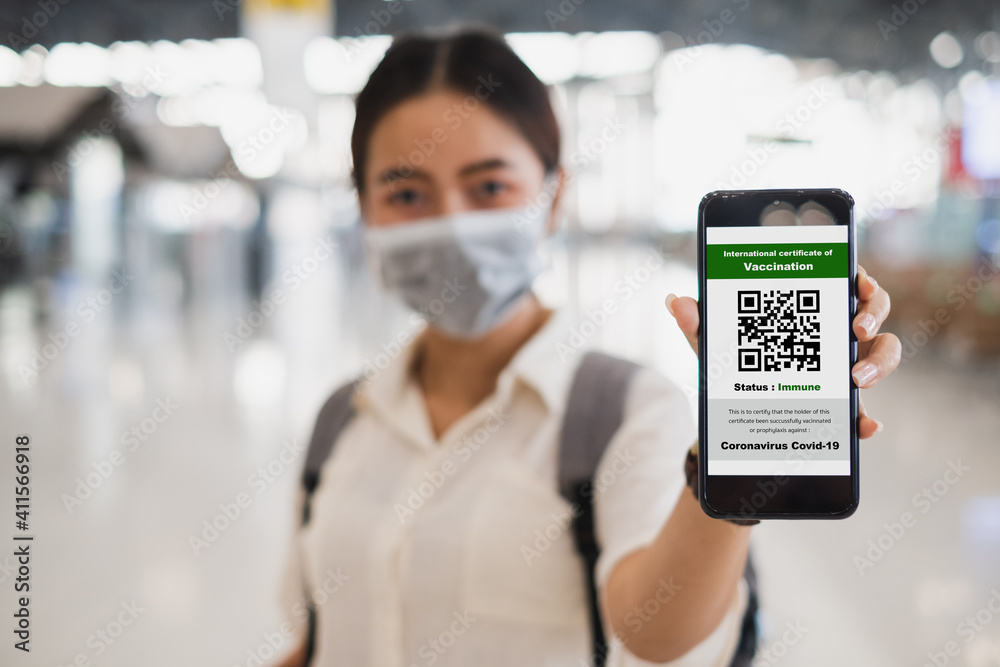 Traveler shows health passport of vaccination certification on phone at