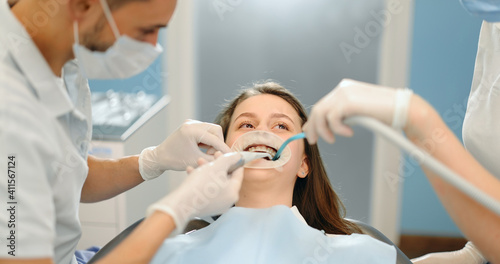 Young dentist wearing optragate for the young patient  preparing for the dental checkup. Regular visit to the orthodontist. 4k video screenshot  please use in small size