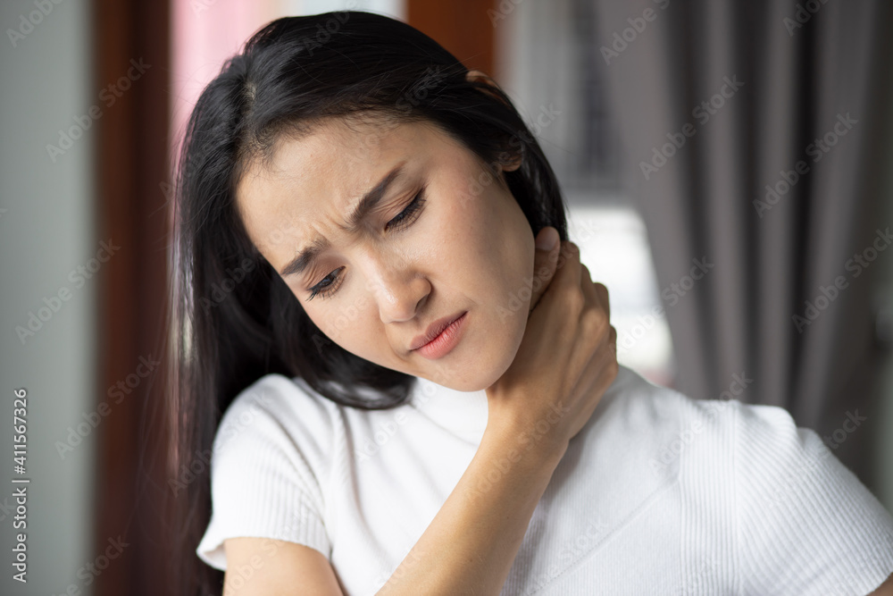 woman with shoulder or neck pain, portrait of asian woman suffering from shoulder or neck pain, stiffness, injury, chronic bone or muscle injury concept woman with shoulder or neck pain, portrait of asian woman suffering from shoulder or neck pain, stiffness, injury, chronic bone or muscle injury concept