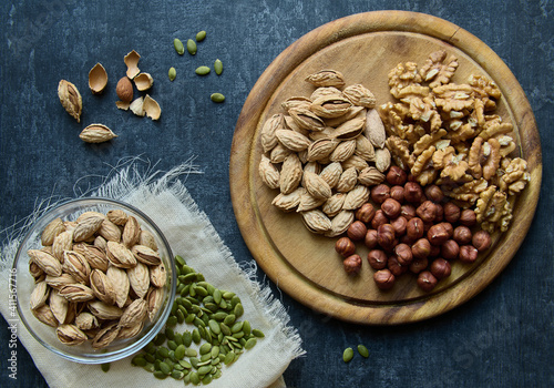 Almonds, hazelnuts, walnuts and pumpkin seeds, top view, flat la