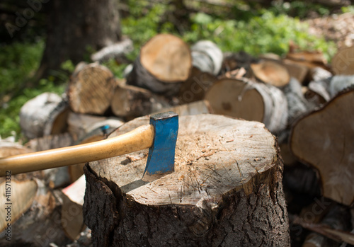 Old axe in the top of a chopping block