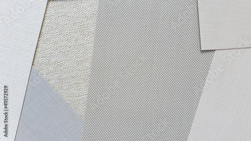 close up detail of roller blind or roman blind fabric samples in bright color tone. interior sunproof fabric samples in various texture and color. roller blind using for heatproof and privacy.