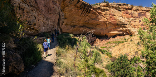 Wide shot of people going to excursions to historic cly town in mesa verde national park in america photo