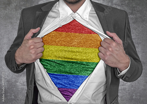 Business man show t-shirt flag of LGBT rips open his shirt