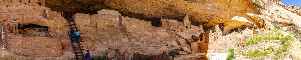 Panorama shot of people in ruins of old historic clay town in mesa verde national park in america