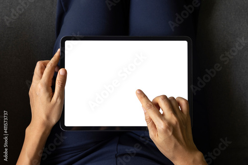 Close-up woman of hand held with digital tablet white screen on sofa in the living room. Concept of technology, connection, communication
