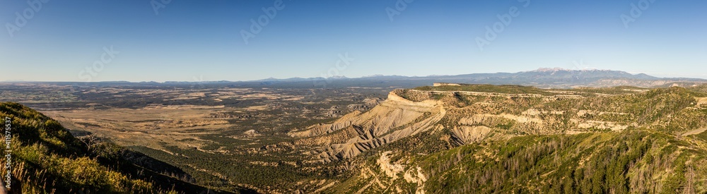 Panorama shot of view to flat valley of america nature from cliff of mesa verde at sunny day