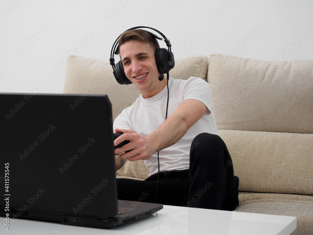 Young gay man playing video games at home Young gay man playing video games at home