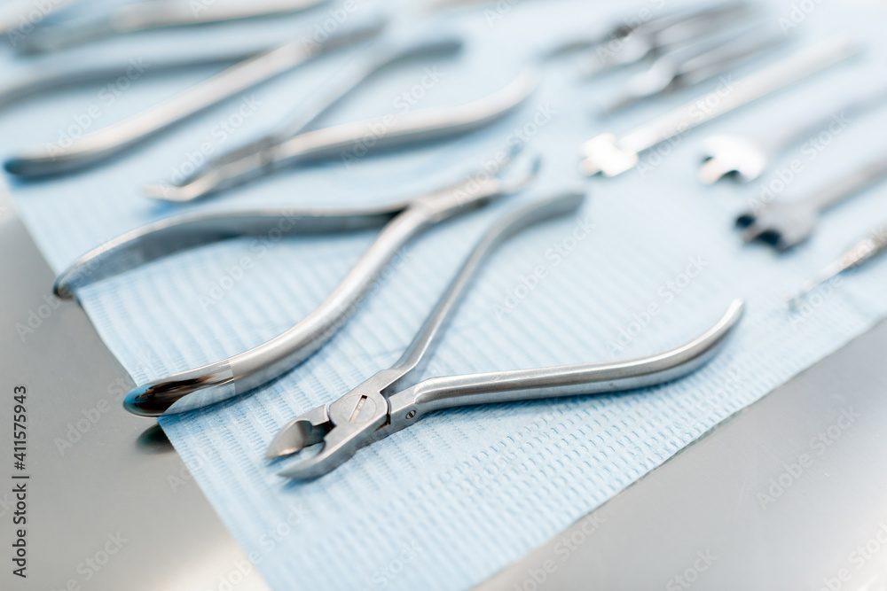 Dental tools for the orthodontic treatment lying on the table at the dental office, close-up. High quality photo Dental tools for the orthodontic treatment lying on the table at the dental office, close-up. High quality photo