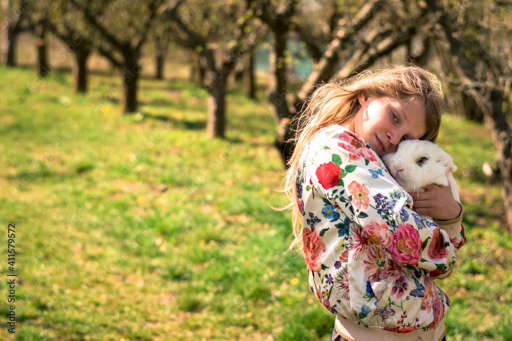 child and rabbit in the garden in spring easter time enjoying time together child and rabbit in the garden in spring easter time enjoying time together