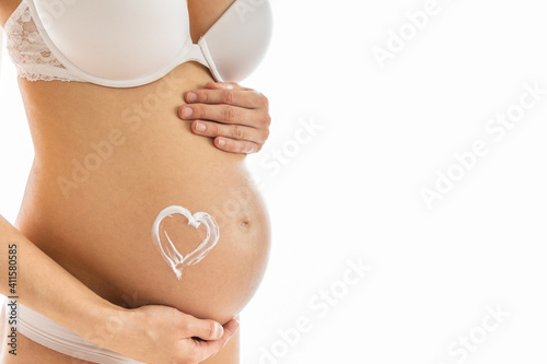 Wallpaper Mural Pregnant woman holds hand on belly. Pregnancy, maternity, preparation and expectation concept. Close-up, copy space, indoors. Beautiful tender mood photo of pregnancy. Torontodigital.ca