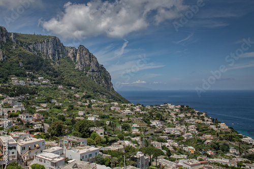Fototapeta Naklejka Na Ścianę i Meble -  Rooftop view of the houses with typical architecture on Capri Island. View on village and the mountains near Marina Grande on the island of Capri, Tyrrhenian sea, Italy