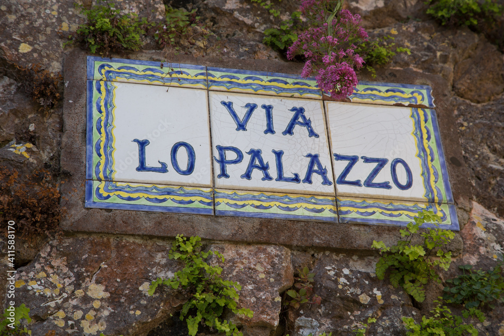 Signpost on the via lo Palazzo - way to palace - on the island of Capri. Typical ceramic signs showing direction to the most famous Capri destinations, Tyrrhenian sea, Italy
