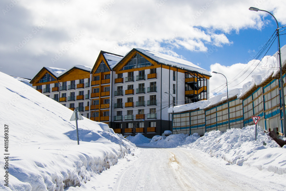 Ski resort, snowy mountains and hostels.