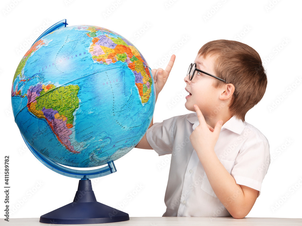 a boy with glasses, an elementary school student, next to a globe, isolate on a white background a boy with glasses, an elementary school student, next to a globe, isolate on a white background