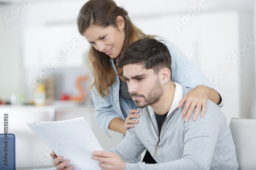 couple reading mail and checking accountancy