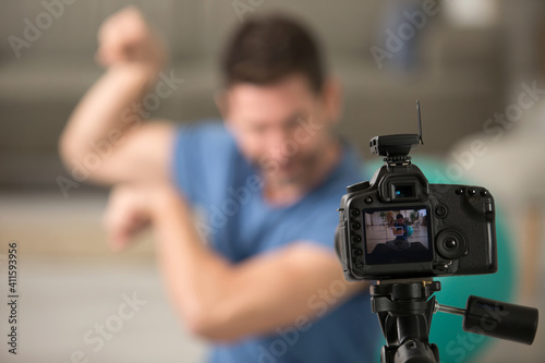 man flexing his muscles for a fitness blog