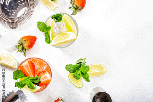 Mojito mocktail set with lime, mint, strawberry and ice on white background. Cold alcoholic non-alcoholic long drinks, beverages and cocktails