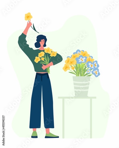 Woman compose bouquet on table. Forist shop or store.