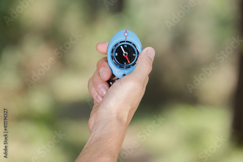 compass in the hand against rural road