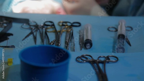  The plastic surgeon's hand picks up the instrument during the operation. Closeup.High quality FullHD footage