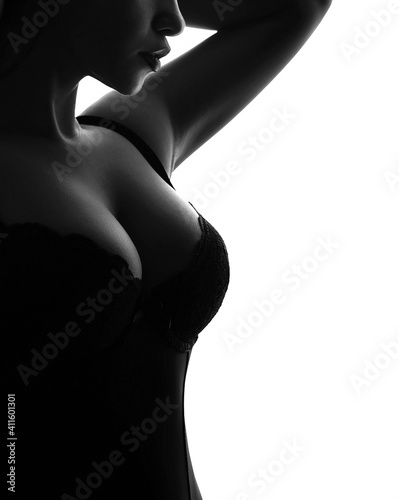 Sensual woman with big breasts in black bra isolated on a white background. The concept of sexy underwear