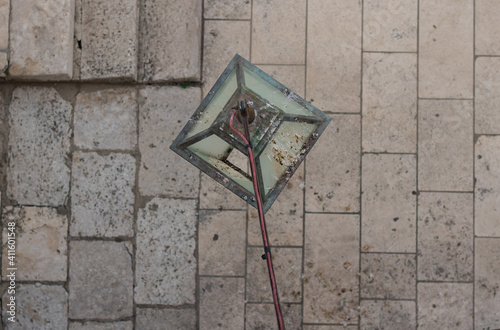 Dirty lamp post covered in pigeon poo in the streets of Dubrovnik Old Town