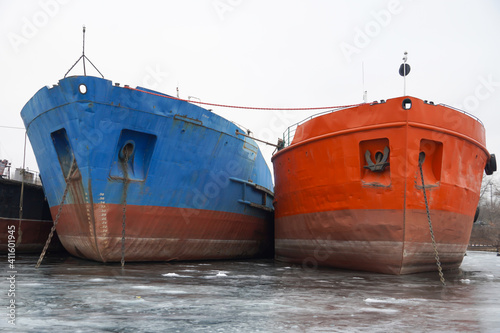 Wintering of ships on a frozen river. Old rusty motor ship. Volgograd. Krasnoarmeisky Zaton. photo