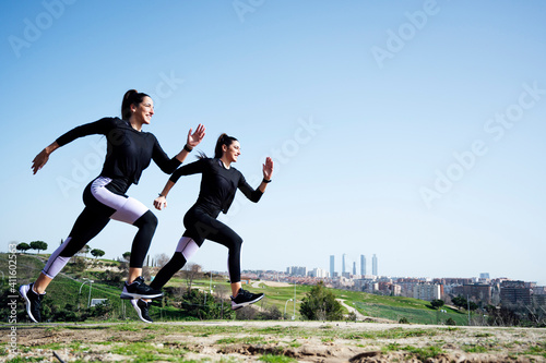 two women running side view