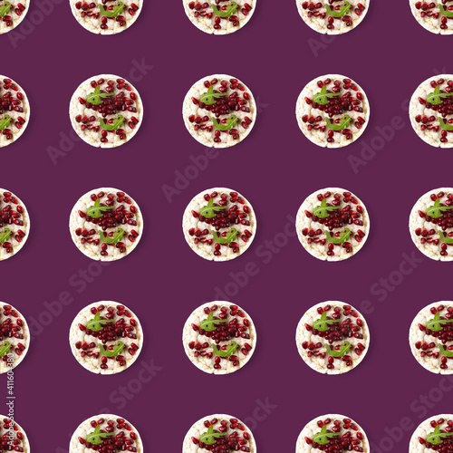 Seamless pattern from galettHealthy breakfast with rice cake and pomegranate on violet flat lay.