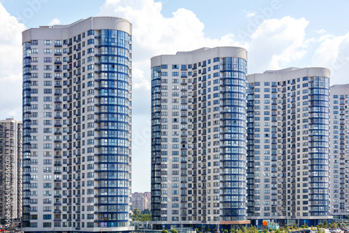 Tall houses of white-blue high-rise buildings in a new district of the city.