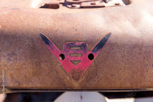 Paint outline left behind on a rusty hood from a car emblem that fell off a classic vehicle long ago