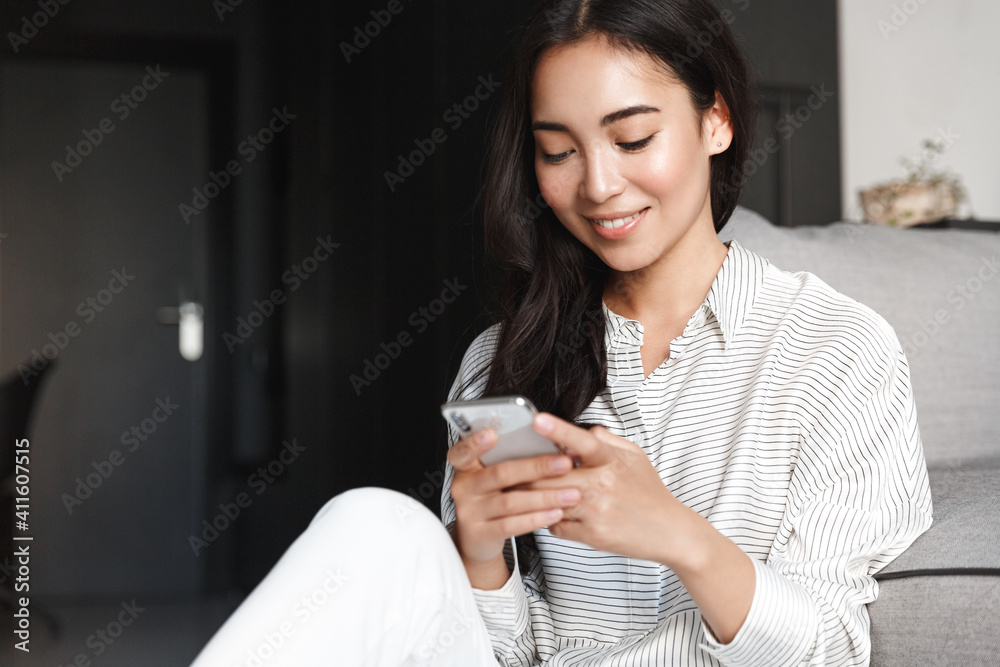 Woman resting at home and browsing social networks on mobile phone Woman resting at home and browsing social networks on mobile phone