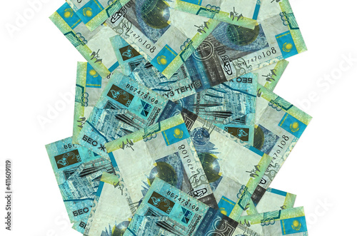 500 Kazakhstani tenge bills flying down isolated on white. Many banknotes falling with white copyspace on left and right side photo