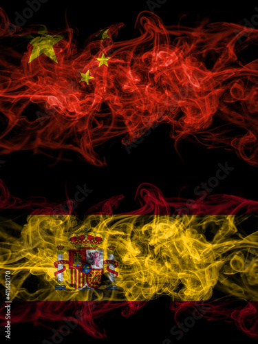 China, Chinese vs Spain, Spanish smoky mystic flags placed side by side. Thick colored silky abstract smoke flags.