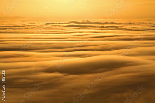 Sunset above the clouds and fog, seen from a mountain