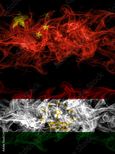 China, Chinese vs Tajikistan smoky mystic flags placed side by side. Thick colored silky abstract smoke flags.