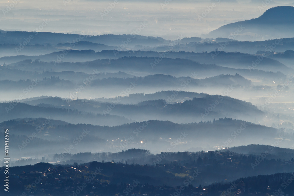 Dust, smoke and smog in the air above a hill landscape around Graz in Austria