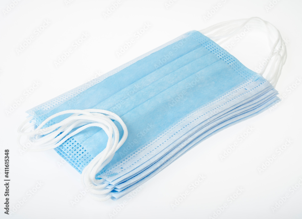 Blue medical disposable masks on white background, protection against coronavirus Blue medical disposable masks on white background, protection against coronavirus