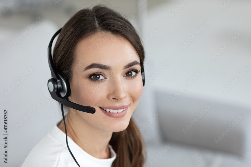Beautiful smiling woman consultant in headphones with a microphone. Beautiful smiling woman consultant in headphones with a microphone.