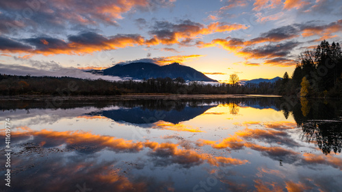 Sunrise over Mount Si as the mountain reflects in Borst Lake in Snoqualmie Washington