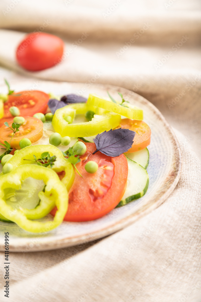 Vegetarian salad from green pea, tomatoes, pepper and basil on white wooden background. Side view, selective focus. Vegetarian salad from green pea, tomatoes, pepper and basil on white wooden background. Side view, selective focus.
